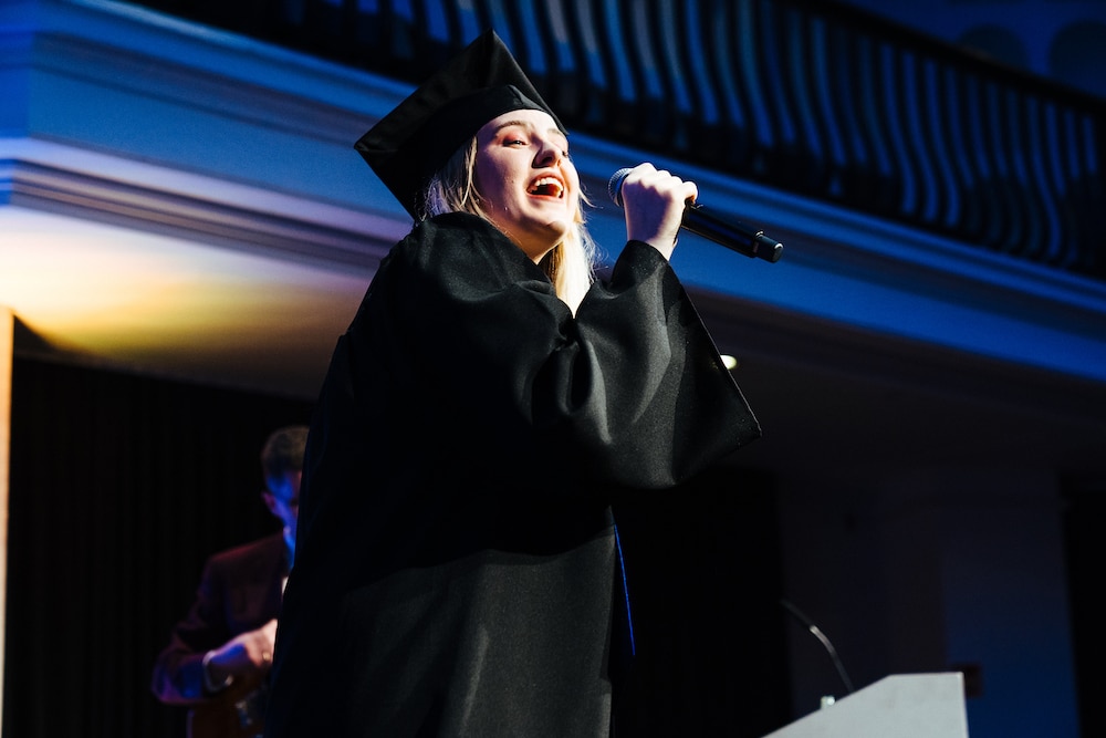 Student holding microphone at BIMM University Berlin Graduation 2019