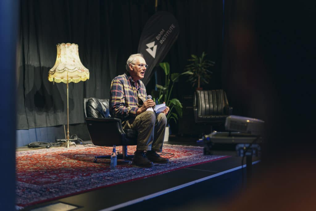 Tim Pope sitting down talking to students