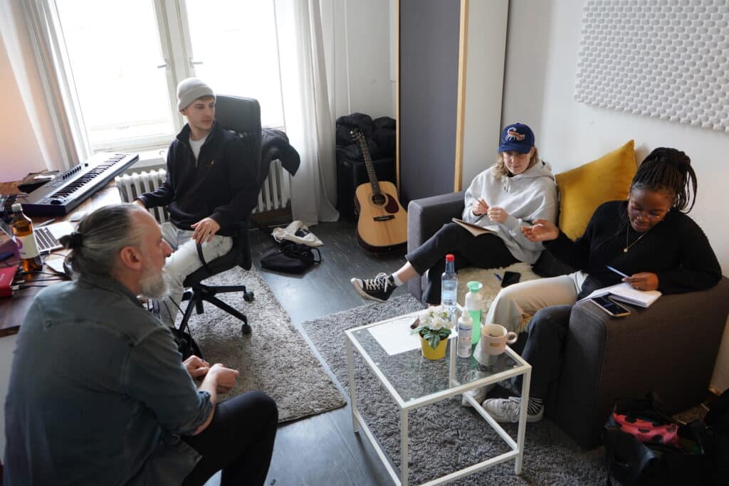 BIMM Berlin students sitting down at a songwriting camp